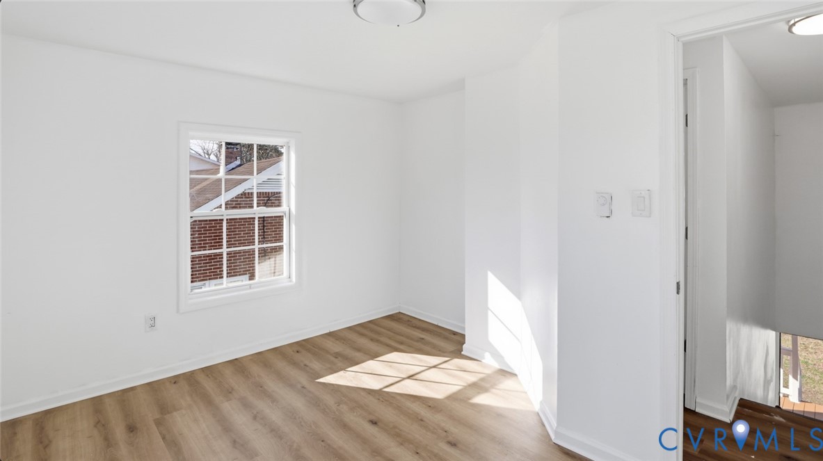205 Cobb Street Franklin, VA 23851 - Photo 44 of 57 an empty room with wooden floor and windows
