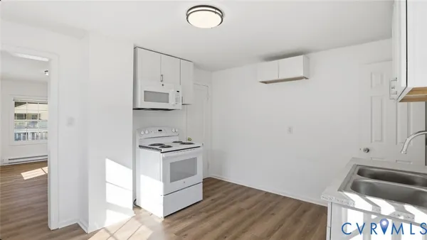 a view of room with wooden floor and window