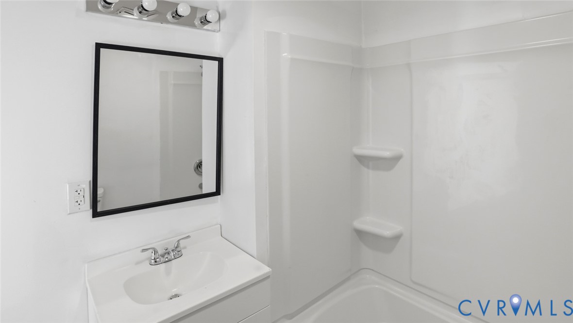 205 Cobb Street Franklin, VA 23851 - Photo 50 of 57 a bathroom with a sink a toilet and mirror