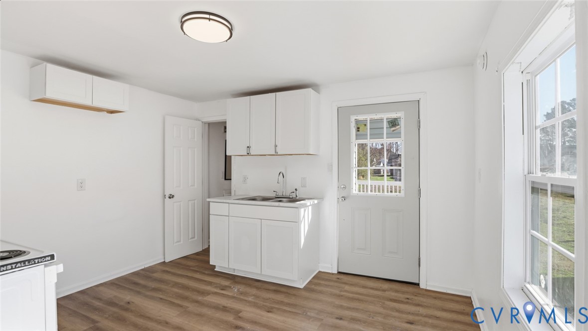 205 Cobb Street Franklin, VA 23851 - Photo 55 of 57 Kitchen with white cabinets, light wood-style floo