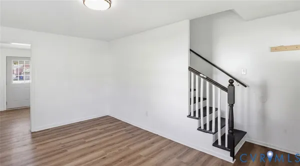 a view of entryway with stairs and wooden floor