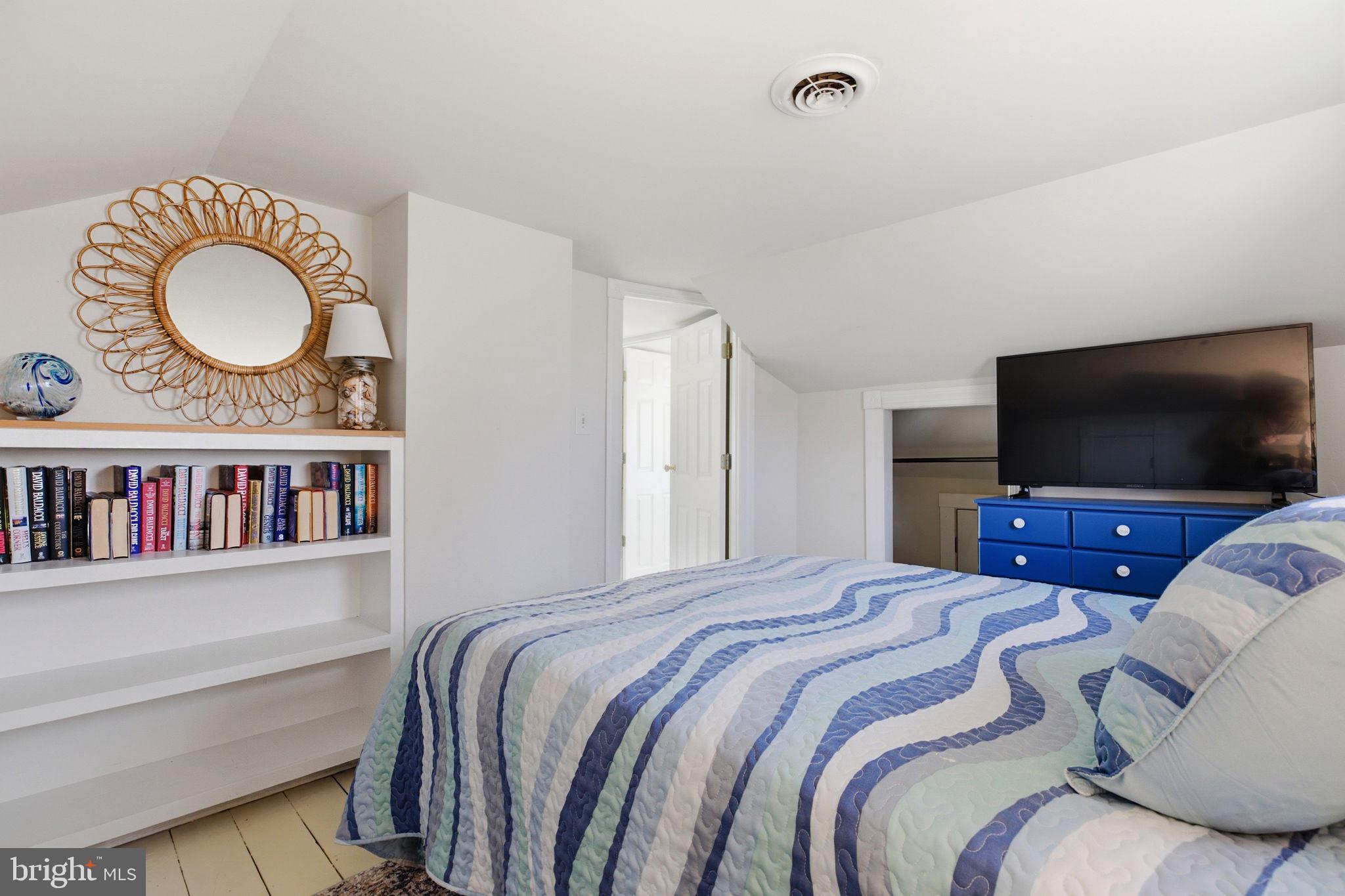 519 Whitehall Road Lancaster, VA 22503 - Photo 27 of 46 a bedroom with a bed and a flat screen tv