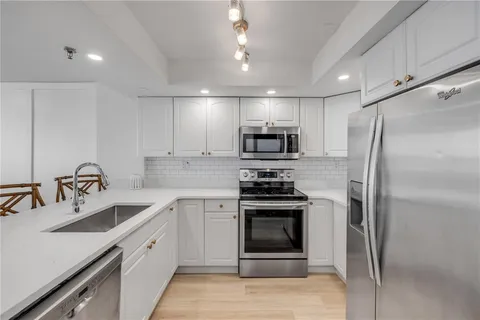 a view of a dining room with furniture wooden floor and chandelier