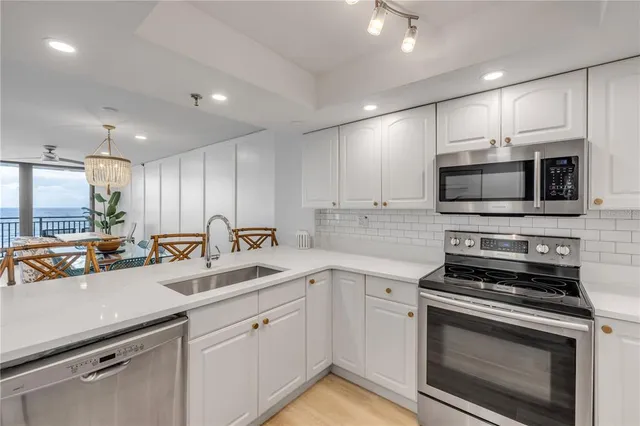 a living room with furniture a flat screen tv and a large window