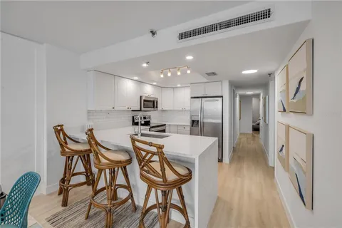a kitchen with a sink stainless steel appliances and cabinets