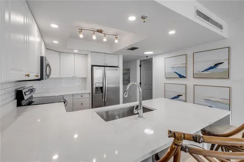 a kitchen with a sink stainless steel appliances and cabinets