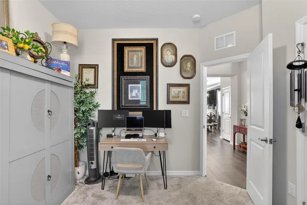 a view of living room with furniture and a clock