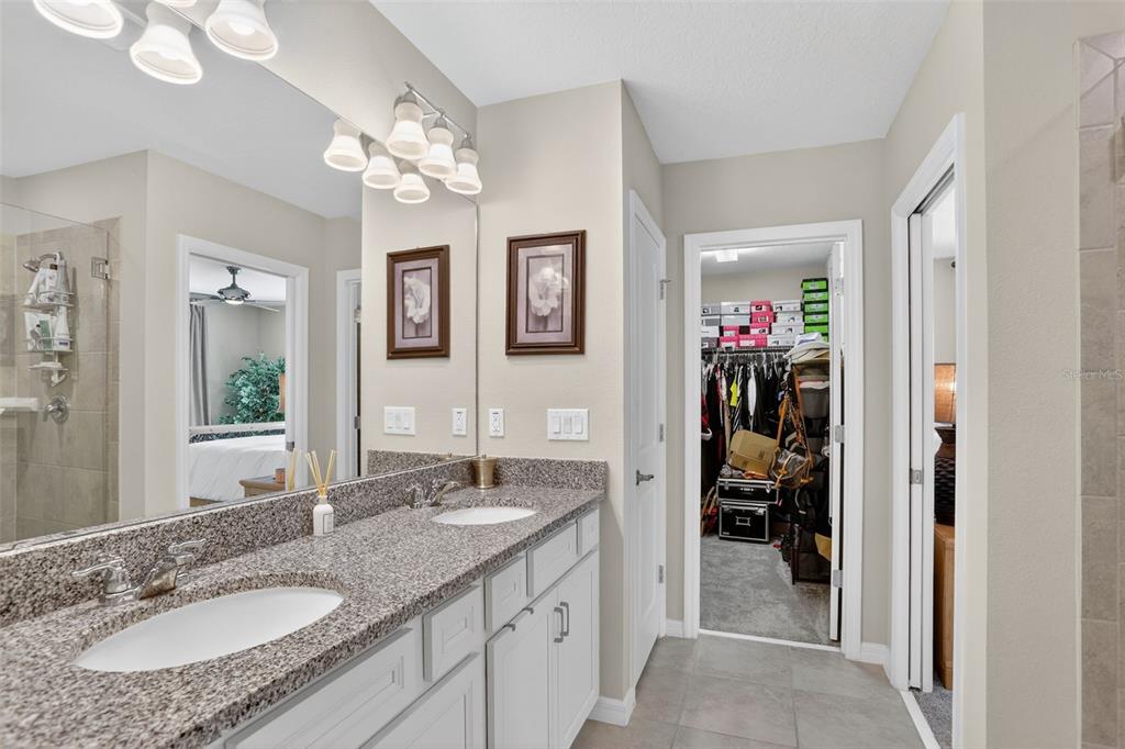 2222 Gopher Tortoise Terrace Oakland, FL 34787 - Photo 29 of 51 a spacious bathroom with a granite countertop sink a mirror and a shower