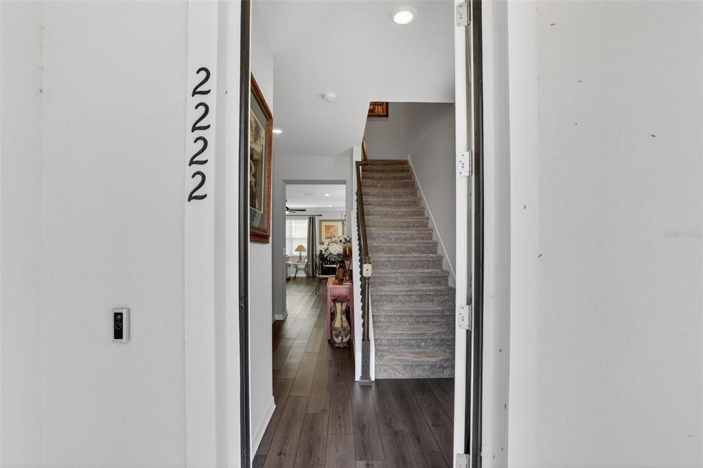 2222 Gopher Tortoise Terrace Oakland, FL 34787 - Photo 3 of 51 a view of a hallway with wooden floor and entryway