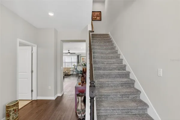 a view of entryway and hall with wooden floor