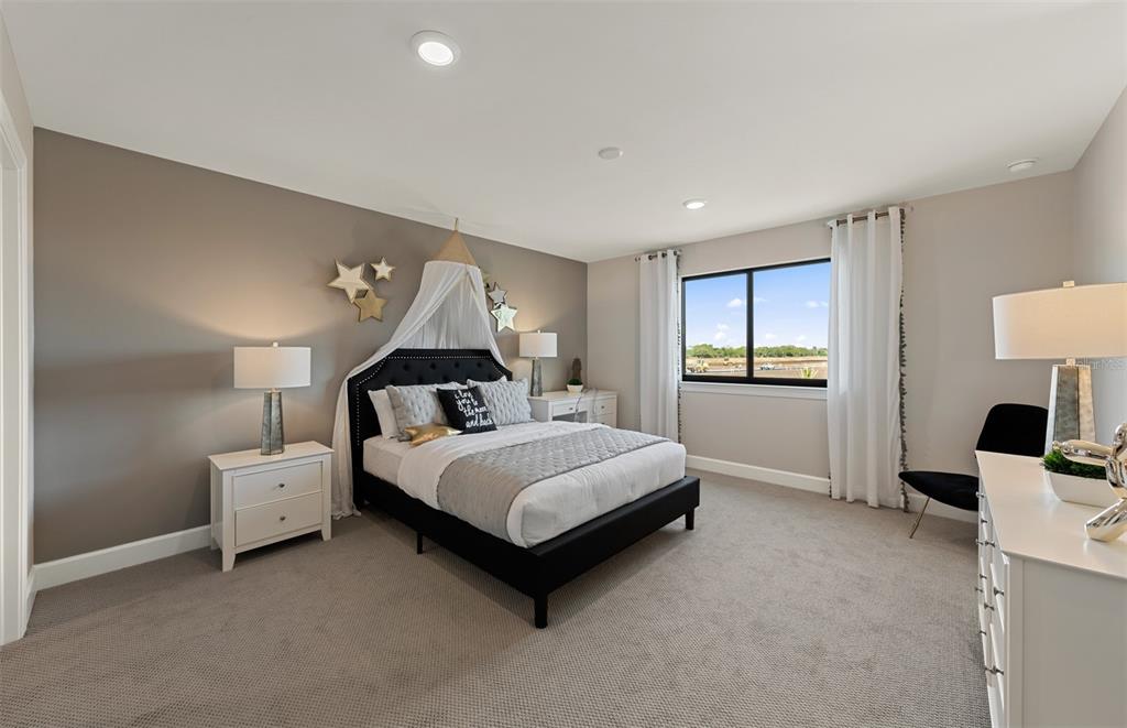 16427 Sapphire Point Drive Lakewood Ranch, FL 34211 - Photo 21 of 30 a spacious bedroom with a bed and a lamp on desk
