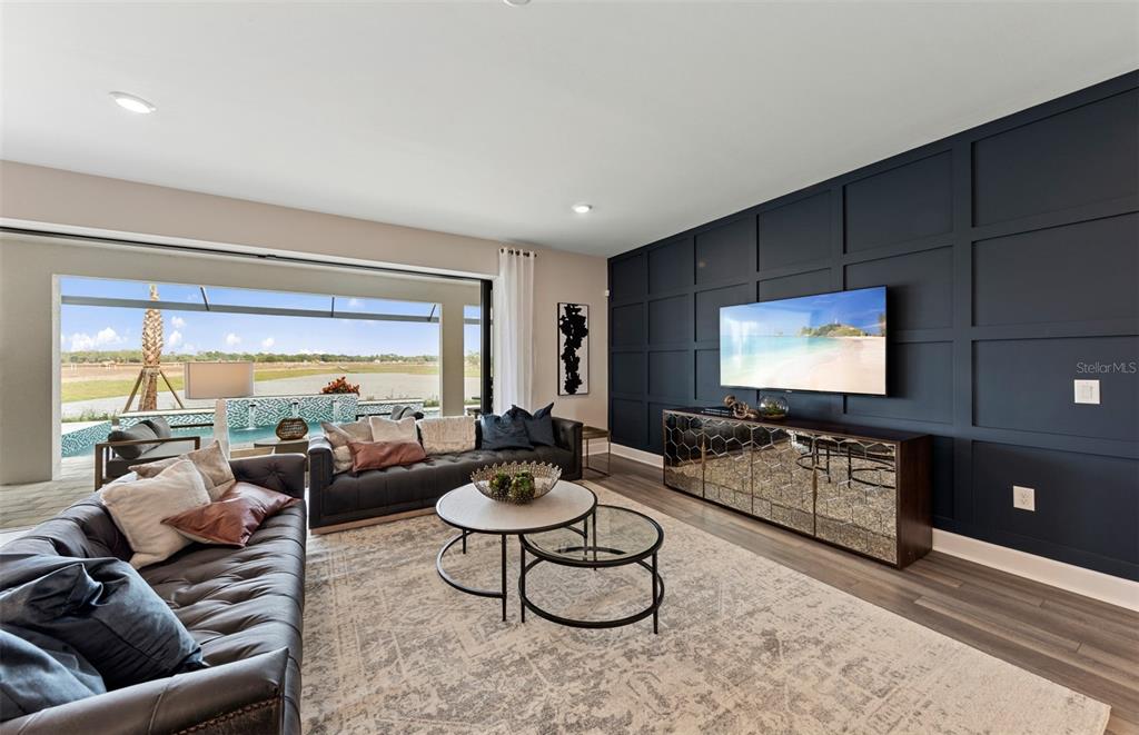 16427 Sapphire Point Drive Lakewood Ranch, FL 34211 - Photo 9 of 30 a living room with furniture and a flat screen tv