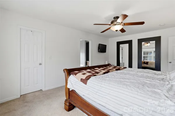 a bedroom with bed and window
