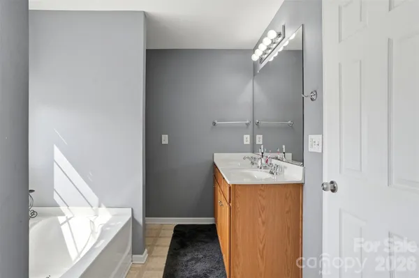 a en suite bathroom with a sink and mirror