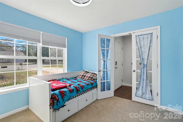 a bedroom with a bed and a window