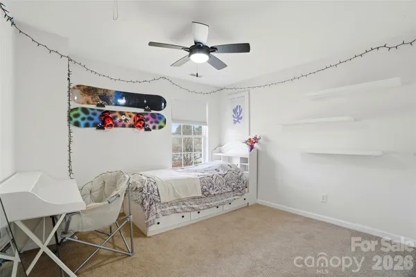 a bedroom with furniture and a chandelier