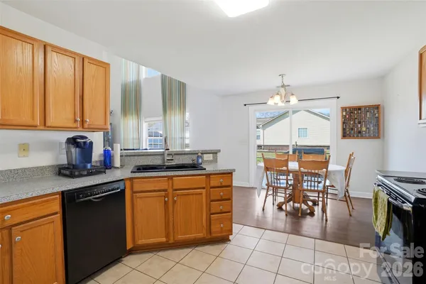 a kitchen with stainless steel appliances granite countertop a stove top oven a sink a counter top space and cabinets