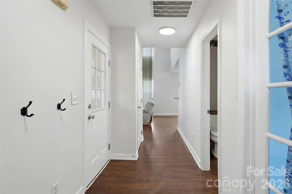 a view of a hallway with wooden floor