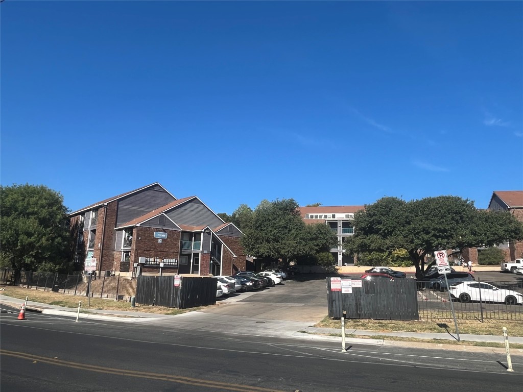 1840 Burton Drive, Unit 184 Austin, TX 78741 - Photo 13 of 23 View of asphalt road featuring sidewalks and curbs