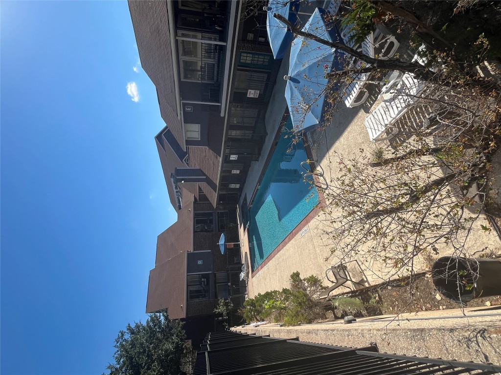 1840 Burton Drive, Unit 184 Austin, TX 78741 - Photo 20 of 23 Community pool featuring a patio