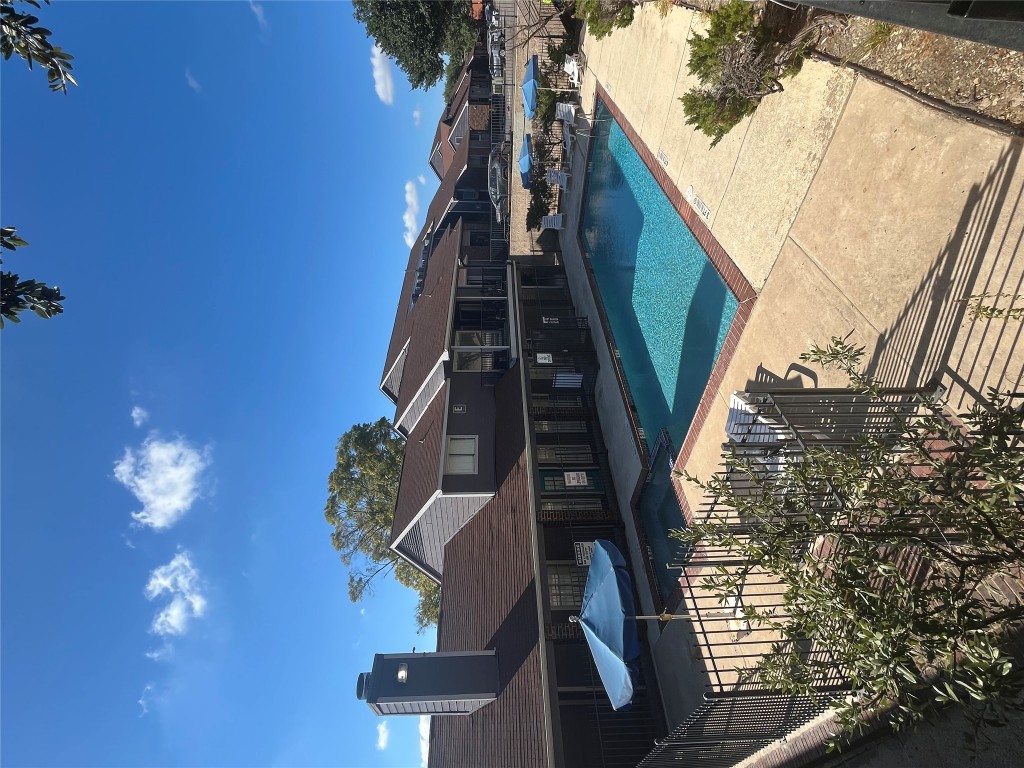 1840 Burton Drive, Unit 184 Austin, TX 78741 - Photo 21 of 23 Community pool with a patio and a residential view