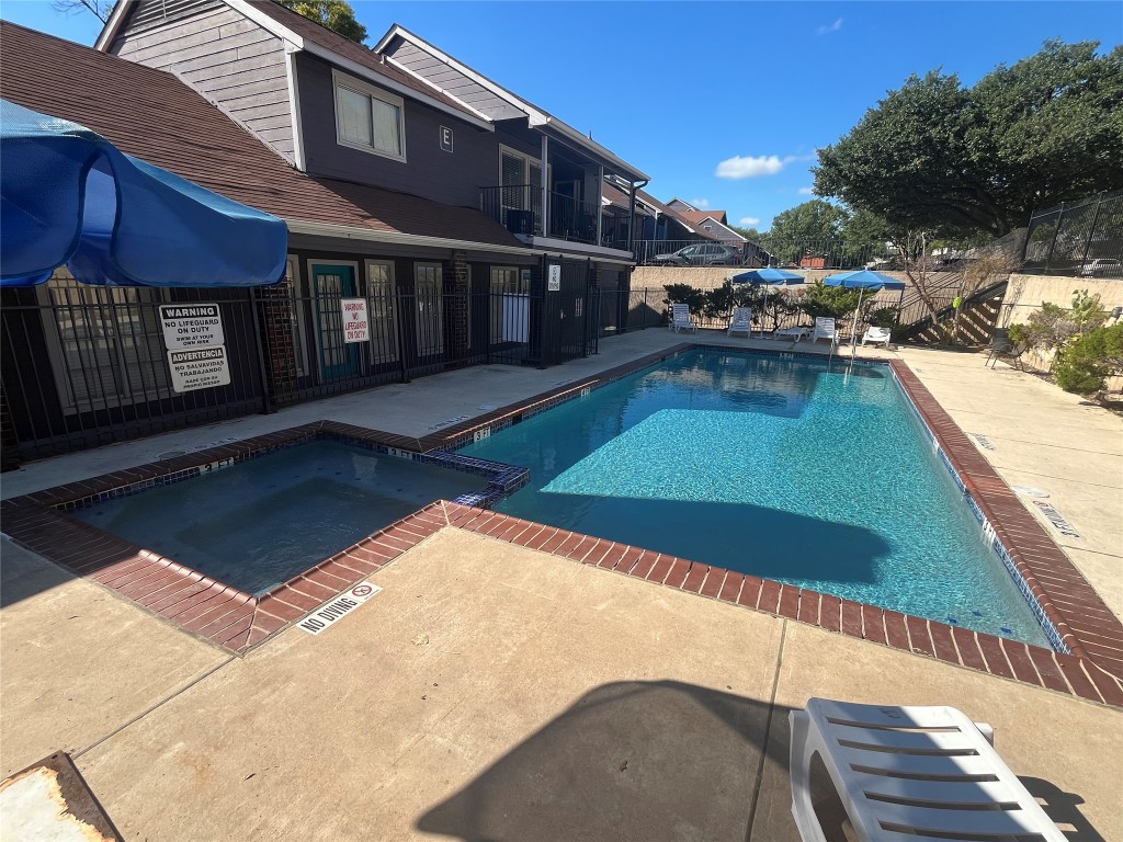 1840 Burton Drive, Unit 184 Austin, TX 78741 - Photo 22 of 23 View of pool featuring a pool with connected hot tub and a patio area