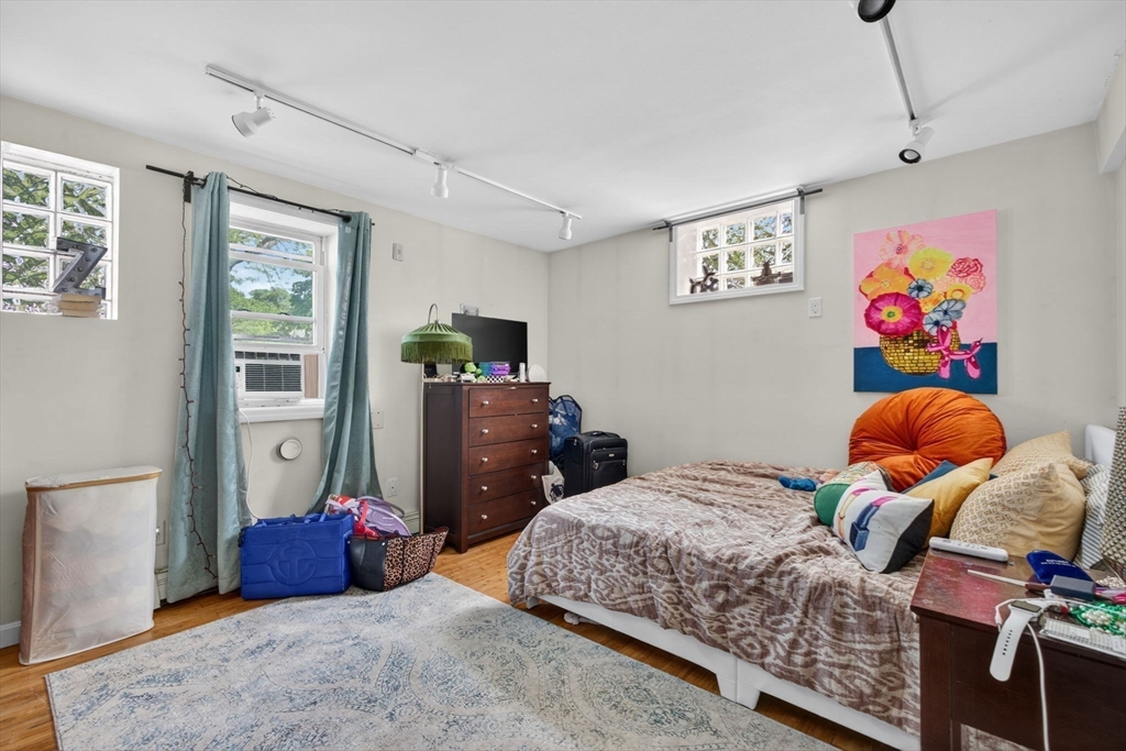 1800 Columbia Road, Unit 6 Boston, MA 02127 - Photo 9 of 11 a bedroom with a bed and wooden floor