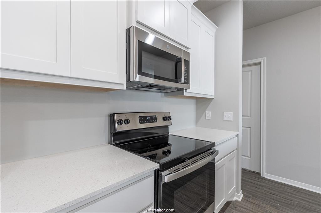 1326 Prairie Drive, Unit 623 Bryan, TX 77803 - Photo 11 of 21 a kitchen with stainless steel appliances a stove a microwave and cabinets