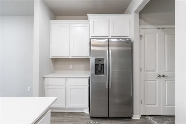a kitchen with metallic refrigerator freezer and a dishwasher