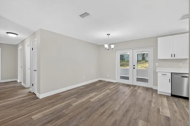 a view of wooden floor and windows in a room