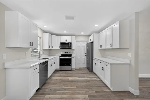 a kitchen with granite countertop a sink and steel stainless steel appliances