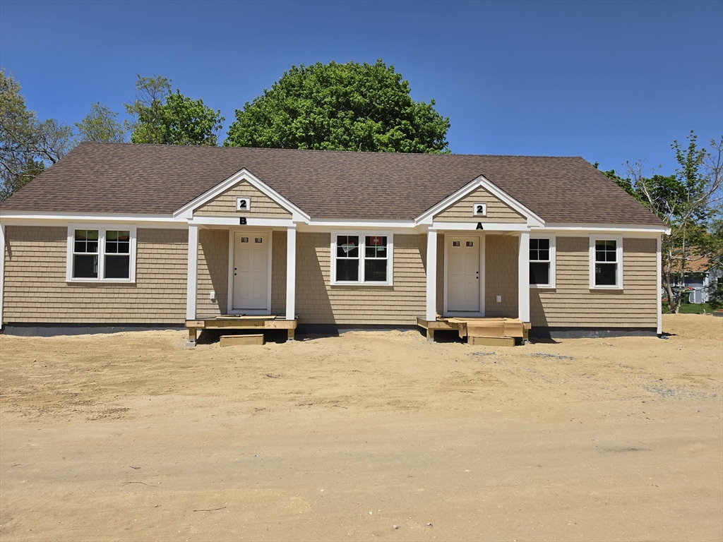 87 Acapesket Road, Unit 2A Falmouth, MA 02536 - Photo 15 of 17 front view of a house with a garden