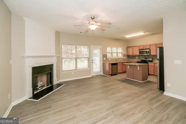 a view of a kitchen with a stove cabinets and wooden floor