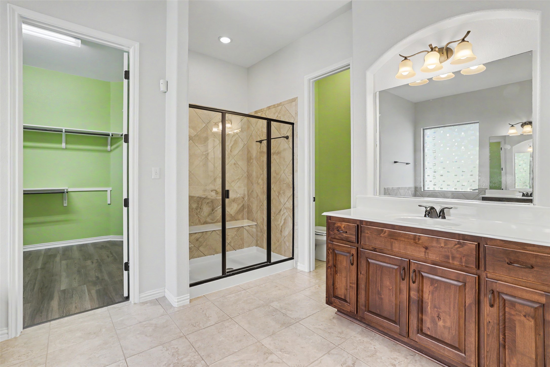 1020 Winding Way Drive Georgetown, TX 78628 - Photo 15 of 32 Bathroom featuring a spacious closet, vanity, a marble finish shower, and light tile patterned floors