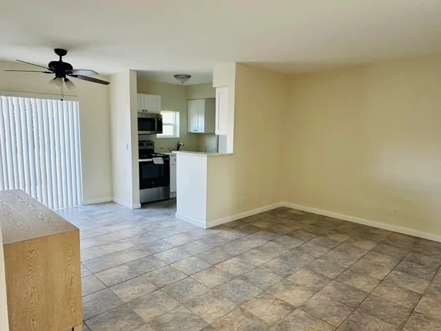 a view of a kitchen with a sink and a refrigerator