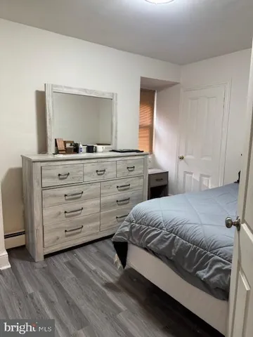 a bedroom with a bed and a dresser