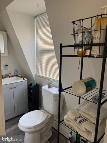 a bathroom with a toilet a sink and a window