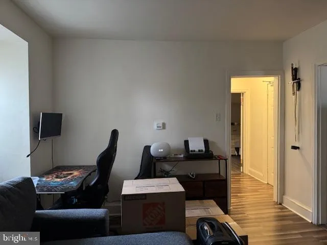a view of a workspace with furniture and wooden floor