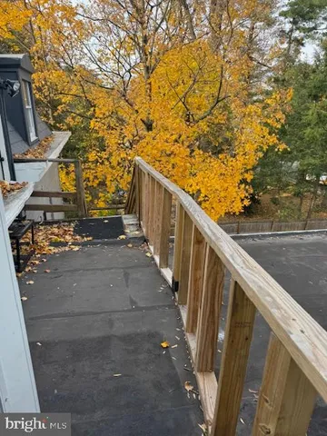 a view of balcony with wooden floor and fence