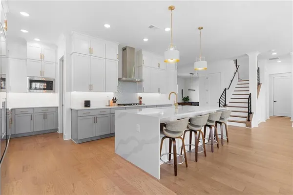 a kitchen with stainless steel appliances white cabinets and a sink