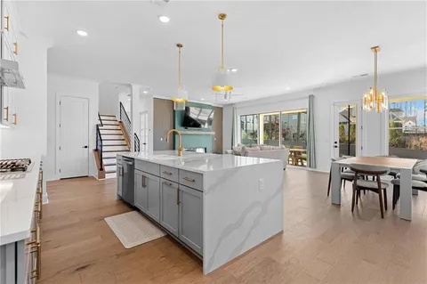 a kitchen with stainless steel appliances granite countertop a stove a sink and a refrigerator