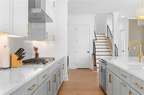 a kitchen with a sink stove and cabinets