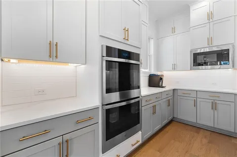 a view of a dining room with furniture wooden floor and chandelier