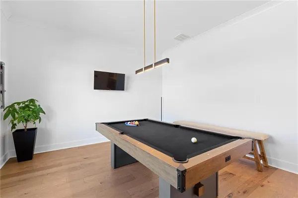 a living room with furniture and a to ceiling window