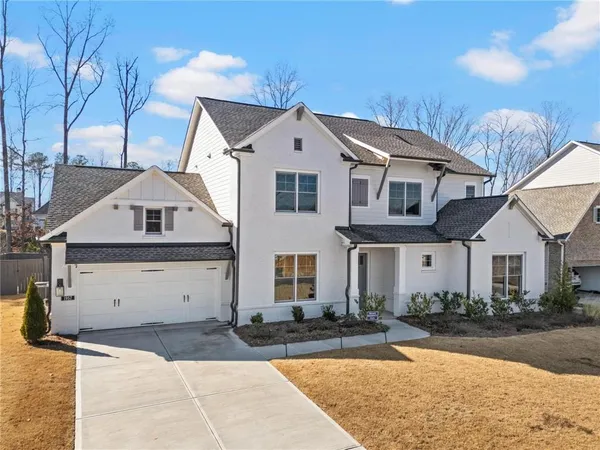 a front view of a house with a yard and garage