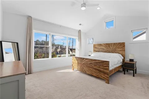 a bathroom with a tub shower and mirror
