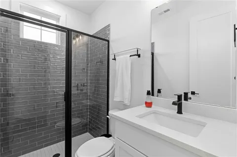 a living room with furniture a flat screen tv and windows