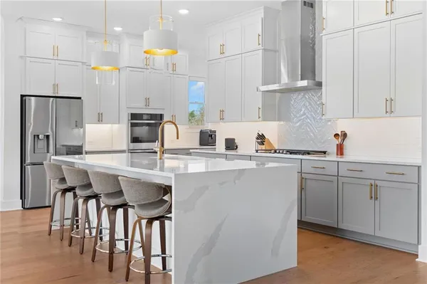 a kitchen with white cabinets and white appliances