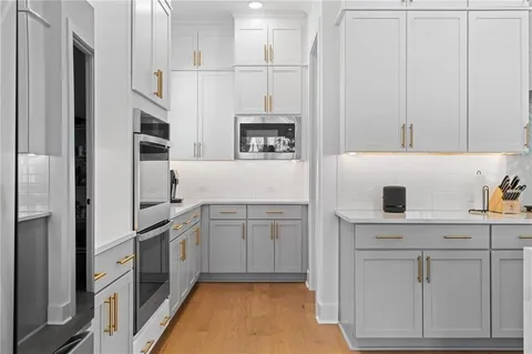a kitchen with a sink a stove and cabinets
