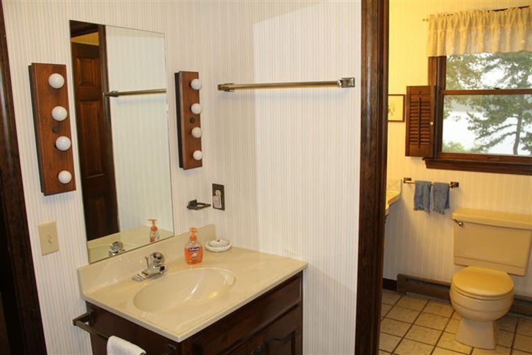 62 Turning Mill Road Brewster, MA 02631 - Photo 22 of 27 a bathroom with a sink toilet and mirror